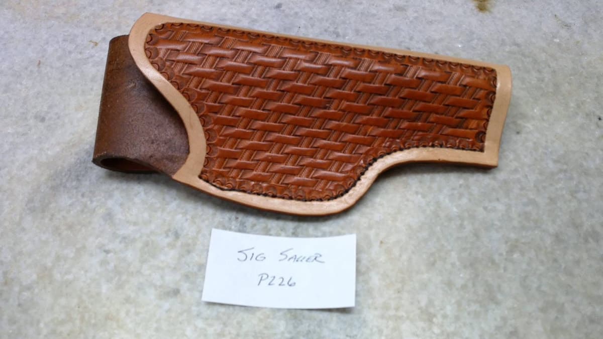 Basketweave leather holster with two belt slots, photographed without a firearm