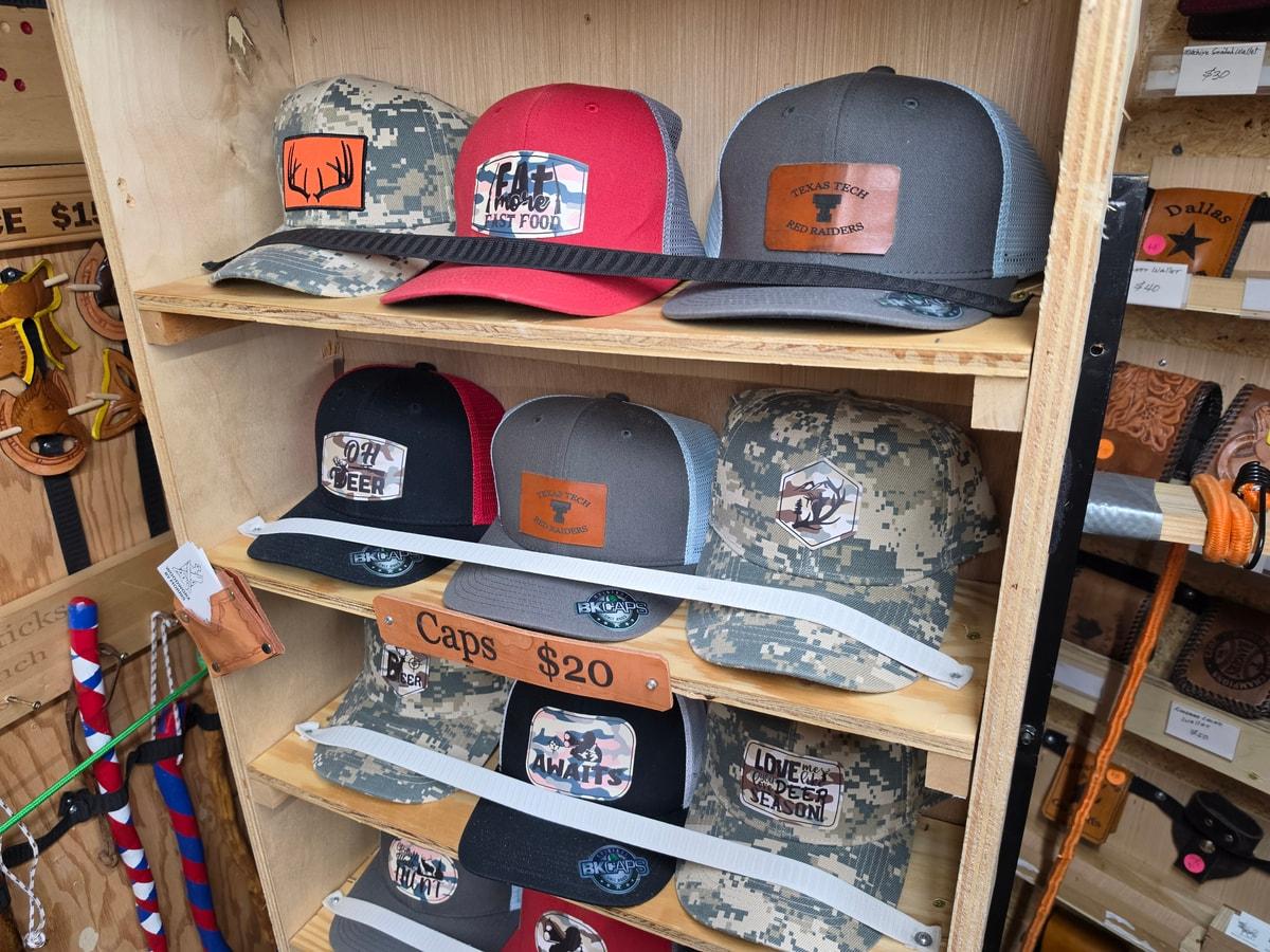 Caps on wooden shelves with leather patches bearing different engraved designs