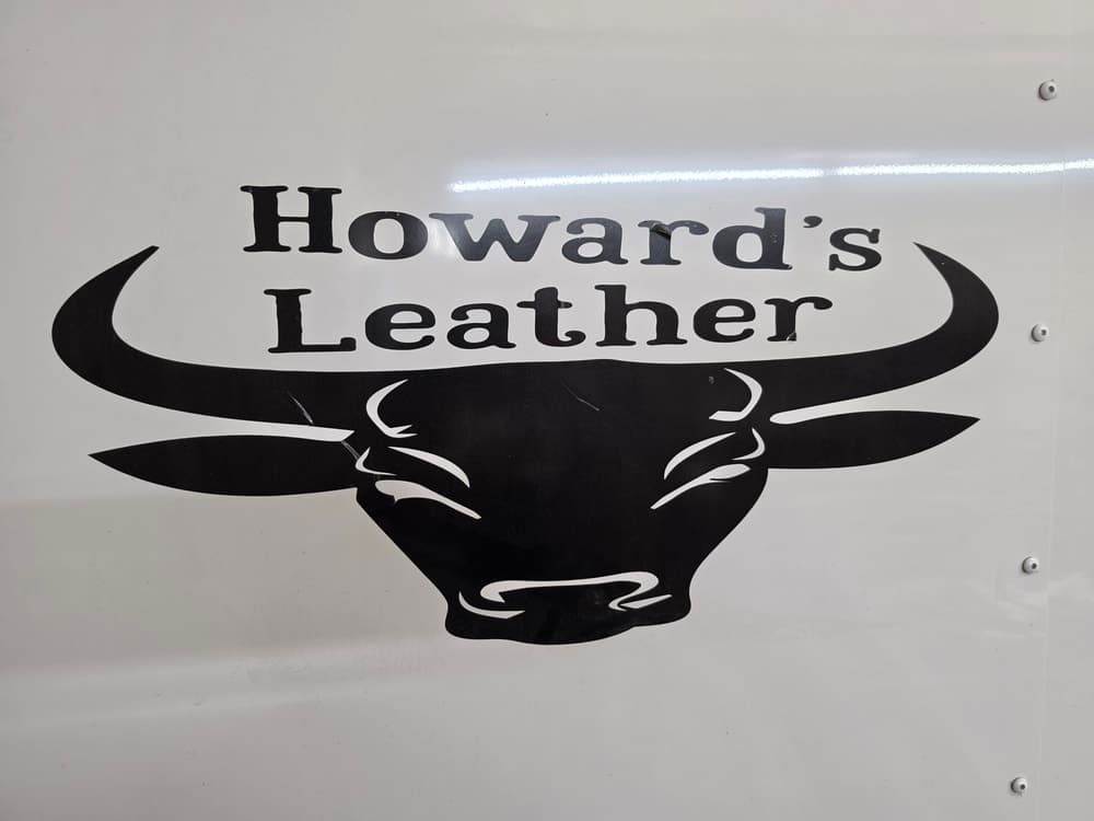 Physical Howard’s Leather sign with a black longhorn graphic