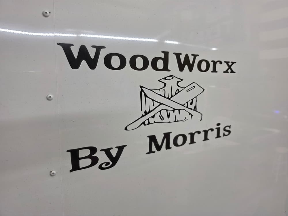 Physical WoodWorx By Morris sign showing crossed woodworking tools